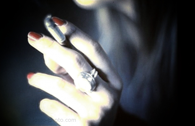 red nailpolish, jewellery and a cigarette