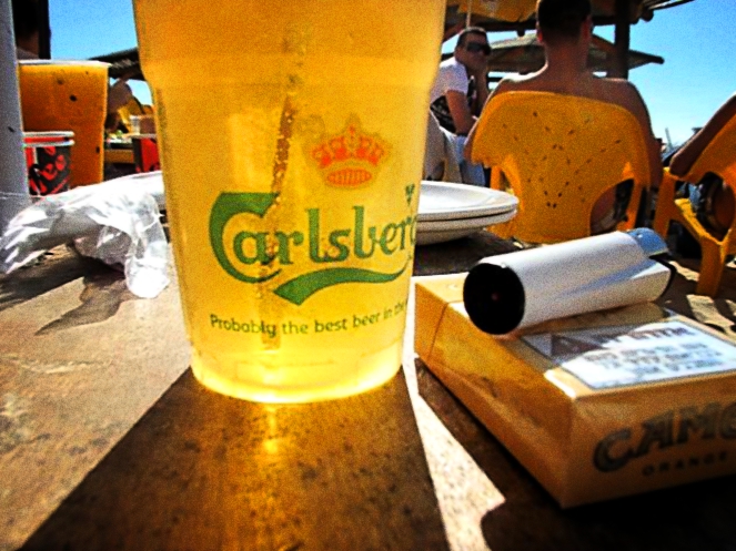 having a beer on the beach in telaviv